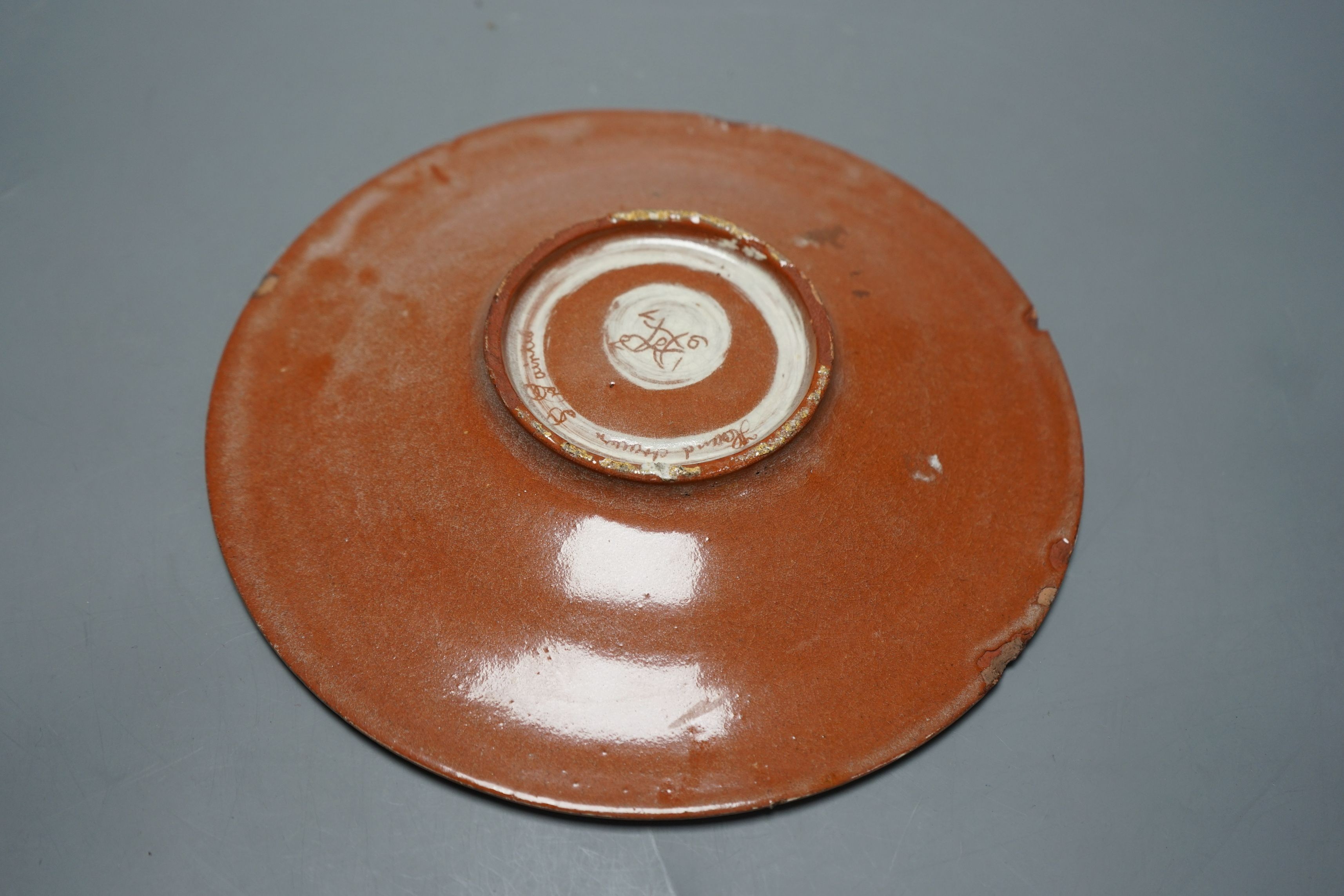 A Carlo Manzoni terracotta dish, sgraffito mark, 27cms diameter